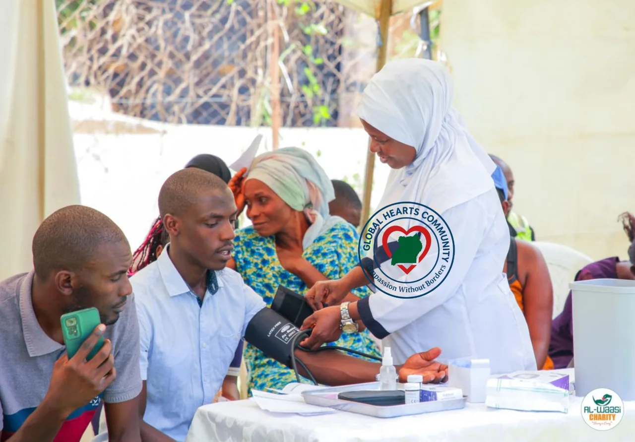 Additional photo from Global Hearts Community’s health outreach gallery: a local health worker checks a community member’s blood pressure.